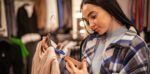 Woman checking the price tag on an item of clothing